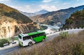 A bus moves along mountain road against the background of a mountains Royalty Free Stock Photo