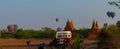 Bus Pagoda Stupa and hot air balloon over Bagan