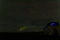 Bus parked ready to witness Northern Lights Appear through the Clouds