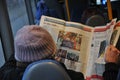 Bus passenger male reading leading danish daily Politiken