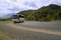 Bus on serpentine road in mountains