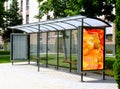 Bus shelter and bus stop. glass light box side ad panel. colorful sample image for mock-up Royalty Free Stock Photo