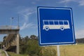 Bus station traffic signal in countrifield with a peatonal brige at background and blue sky Royalty Free Stock Photo