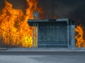 Bus stop and fire huge behind it Royalty Free Stock Photo