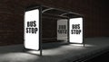 Bus stop with glowing billboard at night Royalty Free Stock Photo