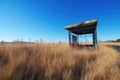 bus stop in the middle of nowhere, with tall grass and clear blue sky above Royalty Free Stock Photo