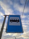 bus stop road sign on background of blue sky and white clouds Royalty Free Stock Photo