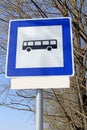 Bus stop road sign in front of a tree
