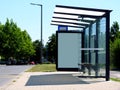 Clear glass design bus shelter with white advertising panel Royalty Free Stock Photo