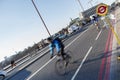 Bus Stop sign on the Blackfriars Bridge, cyclists in the background Royalty Free Stock Photo