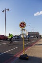 Bus Stop sign on the Blackfriars Bridge, cyclists in the background