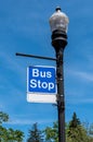 A bus stop sign on a lamp pole in Pittsburgh, Pennsylvania, USA