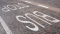 Bus stop sign painted on the tiles on the road Royalty Free Stock Photo