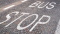 Bus stop sign painted on the tiles on the road Royalty Free Stock Photo