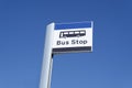 Bus stop sign sky background blue white clouds view below information public transport school old age pensioner travel free coach Royalty Free Stock Photo