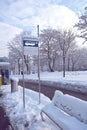 Bus stop sign in snow