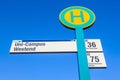 Bus stop sign at the University in Frankfurt am Main under blue sky