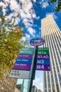 Bus stop signs and skyscrapers in New York City, upward view, USA