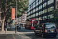 Bus at a bus stop on Tottenham Court Road, London, UK, taxi driving past, motion blur Royalty Free Stock Photo