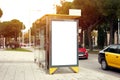 Bus stop with vertical empty billboard placeholder, information banner template, space for mockup layout. Royalty Free Stock Photo