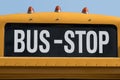 Bus stop written on yellow school bus Royalty Free Stock Photo