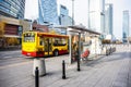 Bus stop with a yellow public transport bus in the city center