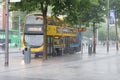 Bus stopping on O`Connell Street in Dublin in havy rain