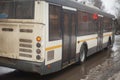 Bus in winter. Transport on the road travels through a puddle Royalty Free Stock Photo