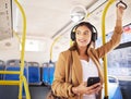 Bus, woman and phone with headphones on public transport, music and smile with business commute. City travel, stop and Royalty Free Stock Photo