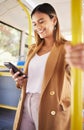 Bus, woman and phone with public transport, social media scroll and smile with business commute. City travel, stop and