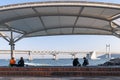 People relaxing and enjoying view of Busan Gwangandaegyo Bridge or Diamond Bridge at Millak Waterside Park in Busan, South Korea