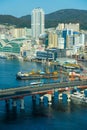 Busan,South Korea-September 2020: Bus passing by Busan Yeongdodaegyo Bridge port with cargo ships and tall buildings on the