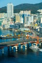 Busan,South Korea-September 2020: Cruise ship passing by Busan Yeongdodaegyo Bridge port with tall building view