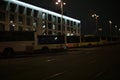 Buses at night in parking lot. City in evening. Parking for public transport Royalty Free Stock Photo