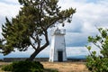 Bush Point Lighthouse, with trees framing the nautical structure on a summer day in Whidbey Island Washington