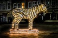 Bush shaped like a zebra decorated with Christmas lights