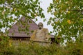 modern coquina stone monument to a kozak warrior in a ruined castle yard renovated ancient tower Busha Ukraine