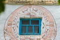 Wall of an old soviet times country house with Trypillya style symbolic paintings around the window