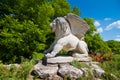 Winged Lion of Saint Mark modern symbolic sculpture, symbolizing evangelist St Mark, on stone pedestal