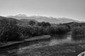 Bushes and reeds along the river and view of Lefka Ori mountain in Georgioupoli village on Crete island