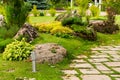 Bushes and stones in the landscape decoration of the flowerbeds