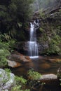 Bushland oasis with pretty waterfall tumbling into rock pool Royalty Free Stock Photo