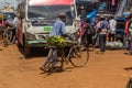 BUSIA, KENYA - FEBRUARY 24, 2020: Man carrying a bunch of bananas on his bicycle in Busia, Ken