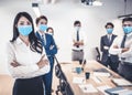 Busines people wearing face mask with presentation of business plan . Business meeting in modern office while pandemic of virus Royalty Free Stock Photo