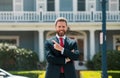 Busines sman standing outside a modern house. Real estate concept. Agent ready to sell home. Royalty Free Stock Photo