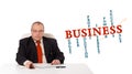 Businesman sitting at desk with business word cloud Royalty Free Stock Photo