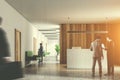 Businespeople in wooden office, reception counter