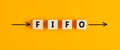 The business abbreviation fifo first in first out written on wooden blocks with directional arrows