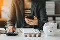 Business accountant working on desk using mobile phone and calculator to calculate budget concept finance and accounting in Royalty Free Stock Photo