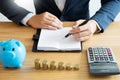 Business accounting man hands working stacking coin the calculator, calculating, financial investment planning and saving concept Royalty Free Stock Photo